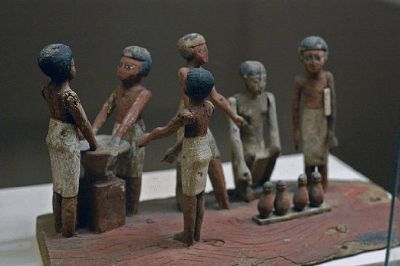 Egyptian miniatures made of wood 3,500 years ago. I think they are breweing beer.