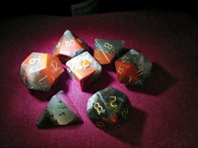 My last set of literal gem dice.  This is my favourite semi-precious stone: bloodstone.

This gives me a full set of unakite (selected because it's basically indestructible, being essentially granite), a full set of bloodstone, and a &quot;mongrel&quot; set of a variety of stones (shown earlier).  And a full set of dice made from dichromic prisms.